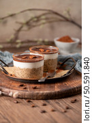 Savor a delectable tiramisu-inspired chia pudding, featuring layers of creamy coffee-infused chia and a decadent chocolate topping. This guilt-free breakfast or dessert blends classic flavors with wholesome ingredients for a convenient and satisfying treat. Стоковое фото, агентство Ingram Publishing / Фотобанк Лори
