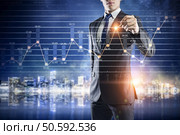 Businessman working on virtual panel with digital infographs. Innovative technologies for business . Mixed media. Стоковое фото, агентство Ingram Publishing / Фотобанк Лори