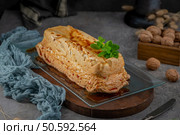 A whole molotof, a traditional caramelized egg white pudding, generously drizzled with sweet syrup and garnished with fresh mint leaves, is presented on a glass serving tray. Стоковое фото, агентство Ingram Publishing / Фотобанк Лори