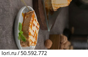 A delicious slice of caramelized molotov, drizzled with extra caramel and adorned with fresh mint, served on a small white dish. Стоковое фото, агентство Ingram Publishing / Фотобанк Лори