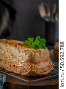 A whole molotof, a traditional caramelized egg white pudding, generously drizzled with sweet syrup and garnished with fresh mint leaves, is presented on a glass serving plate. Стоковое фото, агентство Ingram Publishing / Фотобанк Лори