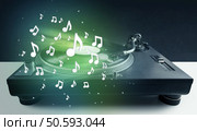 Turntable playing music with audio notes glowing concept on background. Стоковое фото, агентство Ingram Publishing / Фотобанк Лори