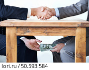 Under-the-table transactions... Стоковое фото, агентство Ingram Publishing / Фотобанк Лори