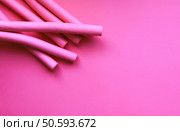 Pink foam curlers on soft pastel background. Hair accessories.. Pink foam curlers on soft pastel background. Hair accessories. Стоковое фото, агентство Ingram Publishing / Фотобанк Лори