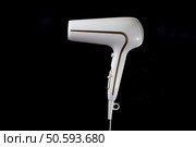 Professional stylish hairdryer isolated over black background. White Ionic Hair Dryer with Hair Care Tool.. Professional stylish hairdryer isolated over a black background. White Ionic Hair Dryer with Hair Care Tool. Стоковое фото, агентство Ingram Publishing / Фотобанк Лори