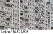 Facade of residential building with many balconies and air conditioners showing urban density. Стоковое видео, видеограф Mikhail Davidovich / Фотобанк Лори