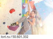 Sporty woman training at bouldering gym without special climbing equipment. Стоковое фото, фотограф Яков Филимонов / Фотобанк Лори