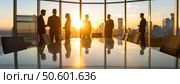 Silhouettes of business professionals in a high-rise boardroom during golden hour reflecting corporate networking and modern work culture. Стоковое AI-изображение, AI-художник Igor Tichonow / Фотобанк Лори