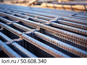 Reinforcing steel bars creating grid structure for construction site. Стоковое AI-изображение, AI-художник Иван Рябоконь / Фотобанк Лори