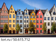 Colorful traditional houses standing in a row in trier, germany. Стоковое AI-изображение, AI-художник Иван Рябоконь / Фотобанк Лори