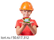 Girl in a helmet holding toy house. Стоковое фото, фотограф Дмитрий Киселёв / Фотобанк Лори