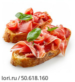 Two bruschetta with parma ham and tomatoes on white background. Стоковое AI-изображение, AI-художник Иван Рябоконь / Фотобанк Лори