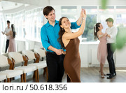 Smiling young girl practicing passionate samba with guy in dance class. Стоковое фото, фотограф Яков Филимонов / Фотобанк Лори
