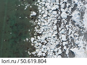 Aerial view of melting ice on the sea coast. Top view of white ice floes on the shore and in sea water. Changing of the climate. Northern nature. Spring season in the Far North. Natural background. Стоковое фото, фотограф Андрей Степанов / Фотобанк Лори