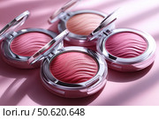 Vibrant color palette featuring powders, blushes, and highlighters arranged on a soft pink background. Beauty and variety of makeup essentials, perfect for cosmetic advertising and creative promotions. Стоковое AI-изображение, AI-художник Ирина Михайличенко / Фотобанк Лори