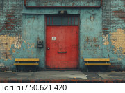 An old industrial scene with a peeling brick wall painted in faded blue and a contrasting red metal door in the center. Bright yellow benches are located on both sides of the door, emphasizing the neglect and atmosphere of the time. The view conveys the mood of an abandoned place or a factory backyard, perfect for urban, post-apocalyptic, street photography or industrial design themes. Стоковое AI-изображение, AI-художник Анна Кривицкая / Фотобанк Лори