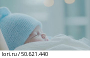 Newborn baby sleeping in blue and white knitted hat and blanket. Стоковое AI-видео, аниматор Анастасия Золотницкая / Фотобанк Лори
