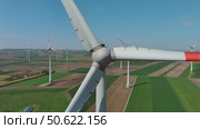 Wind turbines and agriculture fields. Стоковое видео, видеограф Михаил Коханчиков / Фотобанк Лори