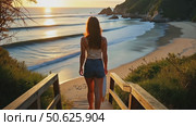 Handheld shot of camera follow young woman in casual clothes and shorts walk down wooden stairs to secluded beautiful beach for evening surfing session. Millennial female girl. Стоковое AI-видео, аниматор Sergey Grishin / Фотобанк Лори
