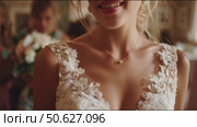 Elegant bride in stunning lace wedding dress prepares for her special day with friends in a beautiful venue. Стоковое AI-видео, аниматор Сергей Толмачёв / Фотобанк Лори