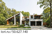 Modern house exterior with large windows and wooded surroundings. Стоковое AI-изображение, AI-художник Андрей Бажанов / Фотобанк Лори