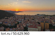 A scenic golden sunset over the historic coastal European city, France, with the sun on the horizon over the sea. Стоковое AI-видео, аниматор Sergey Grishin / Фотобанк Лори