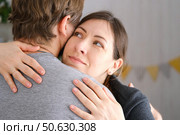 Mature couple hugging hugging each other kissing at home bedroom. Intimate Moment. Tender embrace shared between a loving middle age man and woman, husband and wife. Deep love. Low key, cinematic. Стоковое фото, фотограф Марина Демидюк / Фотобанк Лори