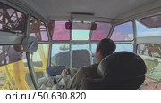 A young man controls a crane, a wide view inside the cabin, a rear view. He loads coal onto a barge with a crane. Northern shipments on the Yenisei River from Krasnoyarsk. Стоковое видео, видеограф Владимир Разгуляев / Фотобанк Лори