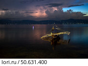 Seascape with Filipino Boat and Distant Thunderstorm. Морской пейзаж с филиппинской лодкой и грозой на горизонте. Стоковое фото, фотограф Никита Костылев / Фотобанк Лори