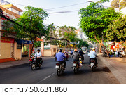 Motorbikes Driving on Street in Ho Chi Minh City, Vietnam During the Day (2024 год). Редакционное фото, фотограф Aleksandr Golubev / Фотобанк Лори