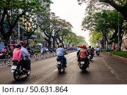 Traffic Along a Busy Street in Ho Chi Minh City, Vietnam on a Sunny Day (2024 год). Редакционное фото, фотограф Aleksandr Golubev / Фотобанк Лори