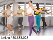 Asian girl with team of like-minded multinational people learn to elements of hip hop dance. Стоковое фото, фотограф Яков Филимонов / Фотобанк Лори
