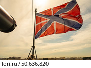 Гюйс. На носовом флагштоке крейсер Аврора на фоне неба. Gues. On the bow flagpole, the cruiser Aurora is depicted against the sky. Стоковое фото, фотограф Алексей Крылов / Фотобанк Лори