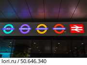 Neon London Underground Roundels and National Rail Symbol. London, UK, 5 May 2024. Редакционное фото, фотограф Zydrius Tartenis / Фотобанк Лори