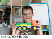 Boy with a truck in his hands. A boy holding a truck in his hands. Стоковое фото, фотограф Роготнева Виктория / Фотобанк Лори
