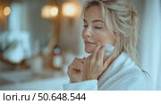 Skincare Routine Update Featuring a Woman Applying Cream in a Bright Bathroom. Стоковое AI-видео, аниматор Юлия Гапеенко / Фотобанк Лори