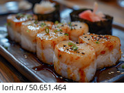 Delicious hotate sushi with sesame seeds and spring onions drizzled with soy sauce. Стоковое AI-изображение, AI-художник Иван Рябоконь / Фотобанк Лори
