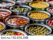 Open tin cans containing preserved food showing abundance and variety. Стоковое AI-изображение, AI-художник Иван Рябоконь / Фотобанк Лори