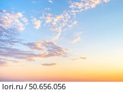 Sky with wispy cirrus clouds illuminated by the setting sun in soft orange tones. Celestial landscape. Стоковое фото, фотограф Коханова Наталья / Фотобанк Лори