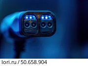 Electric vehicle charger glowing in dark environment. Стоковое AI-изображение, AI-художник Иван Рябоконь / Фотобанк Лори
