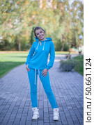Smiling girl in blue tracksuit on street looking at camera. Стоковое фото, фотограф Роготнева Виктория / Фотобанк Лори
