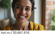 Smiling indian woman looking at camera posing at modern home. Стоковое AI-видео, аниматор Sergey Grishin / Фотобанк Лори