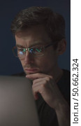 Thoughtful trader analyzing stock market data on laptop. Стоковое видео, видеограф Arsenii Palivoda / Фотобанк Лори