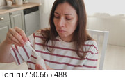 Attractive brunette mid adult woman putting on makeup looking in the mirror. Beautiful lady caring her face. 40 years old female applied cosmetics. Natural beauty and aging concept. Skin care, make-up. Стоковое видео, видеограф Марина Демидюк / Фотобанк Лори