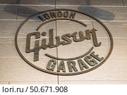 Garage London floor emblem at flagship guitar store entrance. London, UK, 11 May 2024. Редакционное фото, фотограф Zydrius Tartenis / Фотобанк Лори