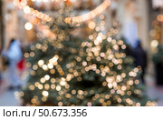 Beautiful Christmas background 2026.Abstract blurred Christmas background with Christmas tree garlands in warm shades. Стоковое фото, фотограф Photojuli / Фотобанк Лори