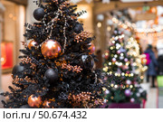 Beautiful Christmas background. Beautiful holiday toys on the New Year's tree in Moscow. Concept of preparation and decoration for the new year 2026. Стоковое фото, фотограф Photojuli / Фотобанк Лори