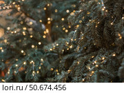 New Year's card 2026. Festive garlands and lights on the Christmas tree. Close-up. Beautiful Christmas background. The concept of decorations and decorations for the new year. Стоковое фото, фотограф Photojuli / Фотобанк Лори