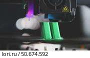 Modern 3d printer creating a green plastic object using innovative technology in a laboratory setting, showcasing the advancements in additive manufacturing. Стоковое видео, видеограф Ольга Ильина / Фотобанк Лори