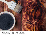 The procedure for protecting and coating wooden boards. The texture of wood treated with stain. Close-up of stain and brush. Стоковое фото, фотограф Photojuli / Фотобанк Лори